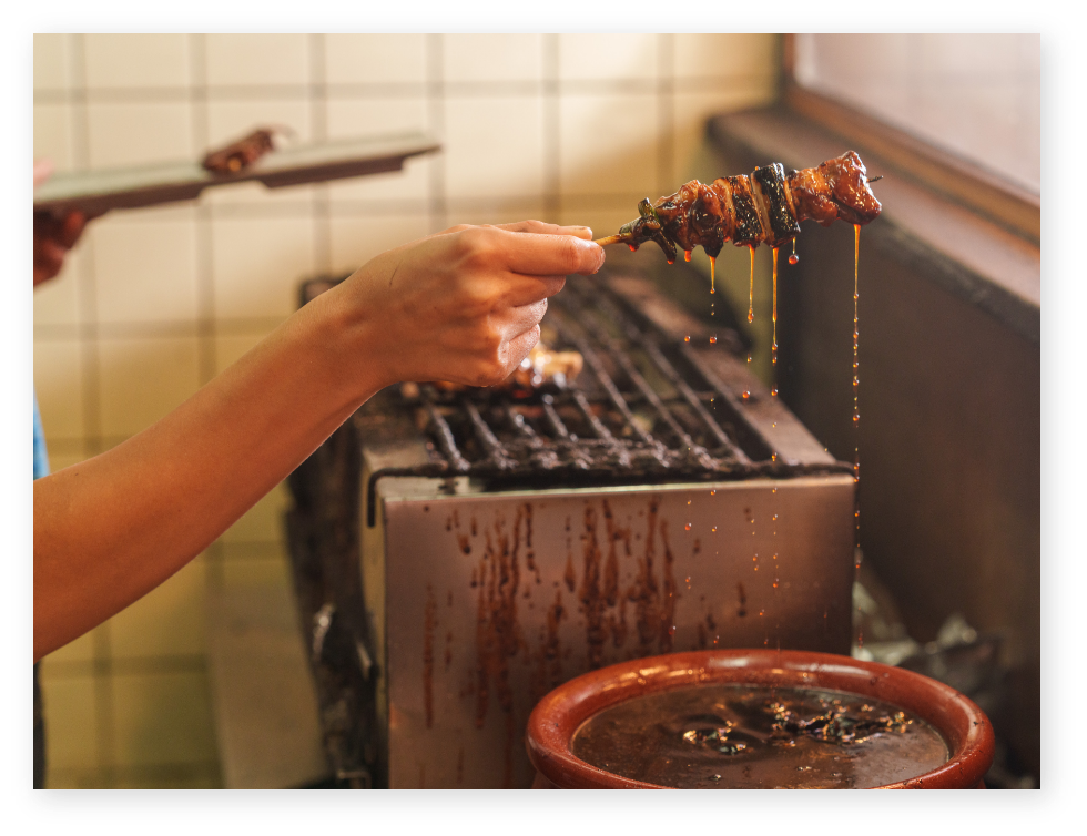焼き鳥をたれにつける様子